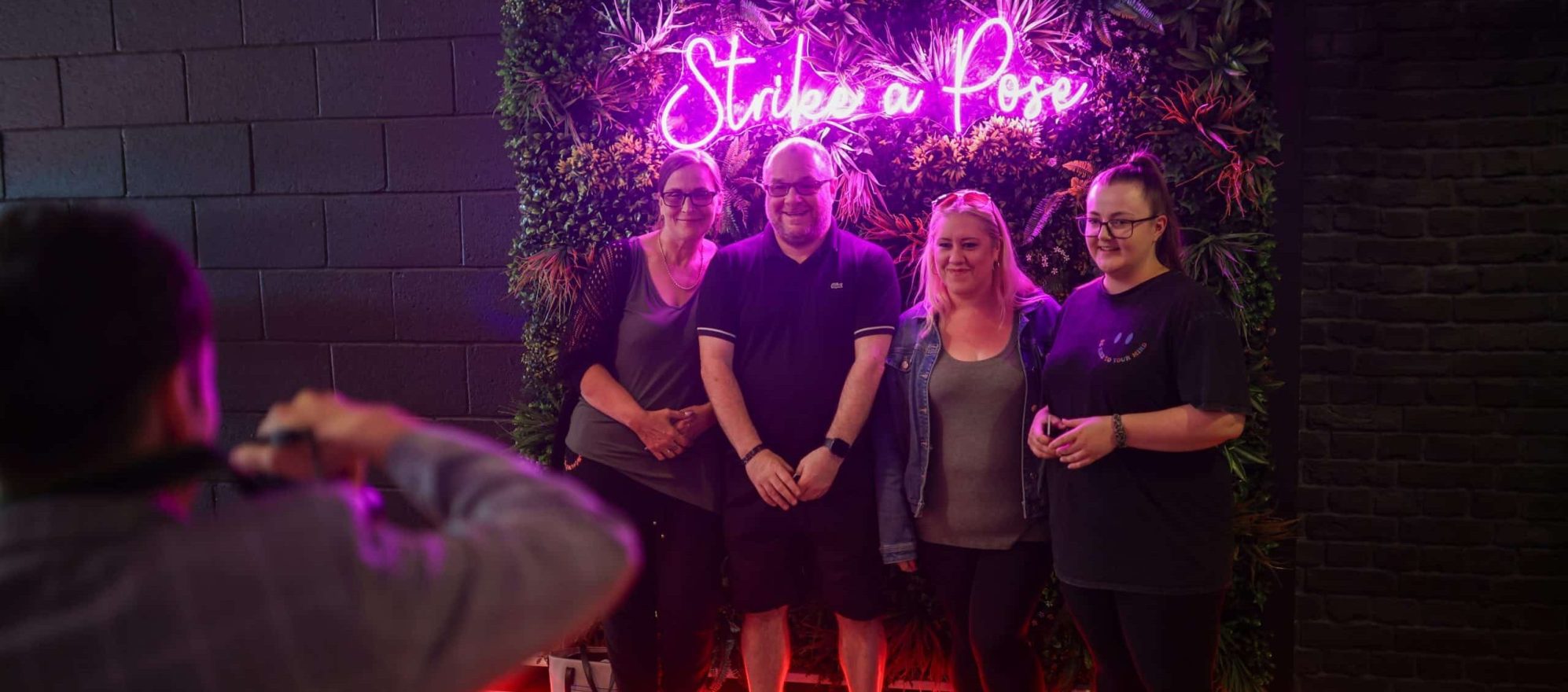Photo opportunity - group of 4 people pose for a photo.